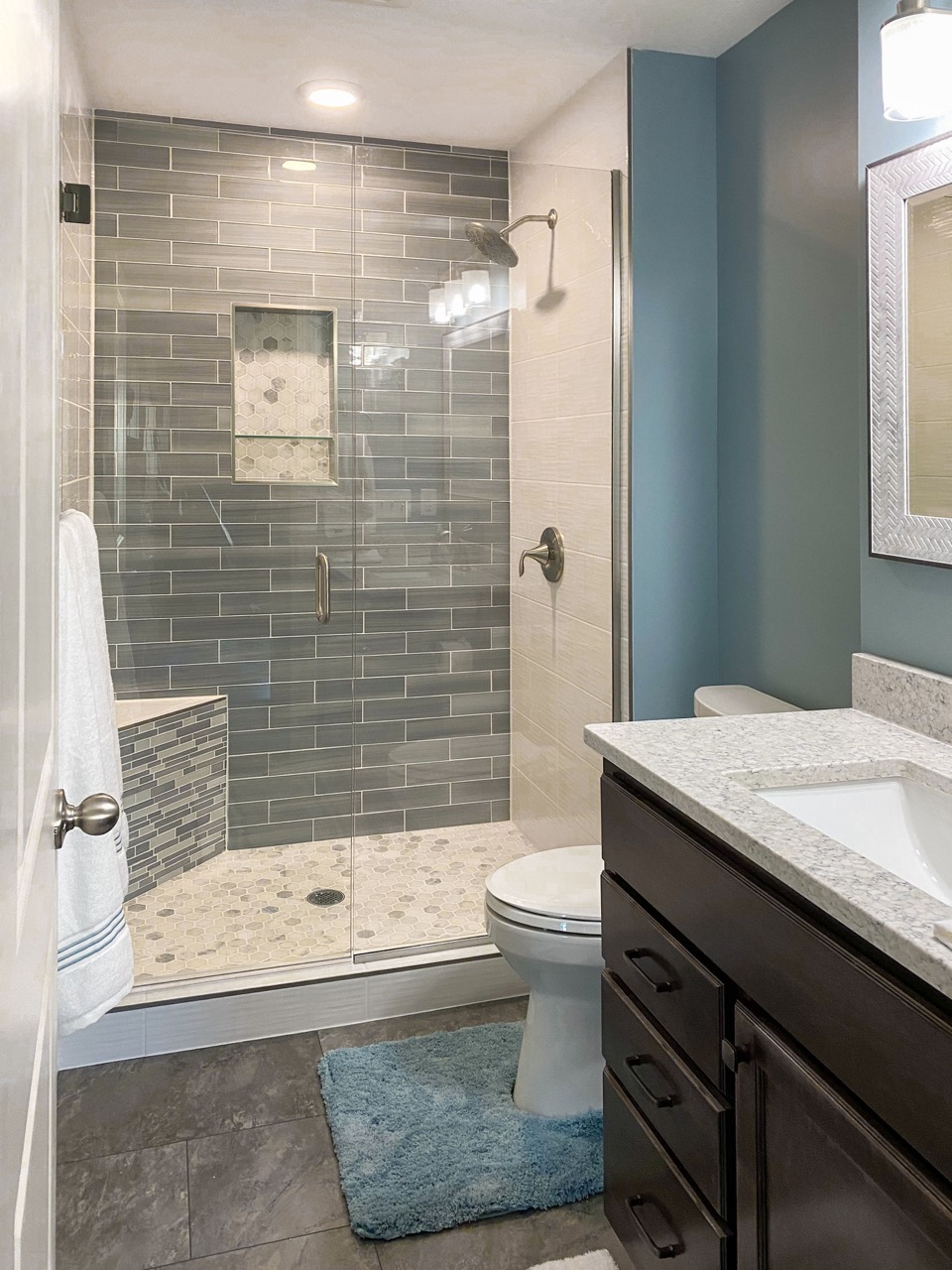 A modern bathroom with teal accents recently renovated by House Lift Inc. of the Twin Cities