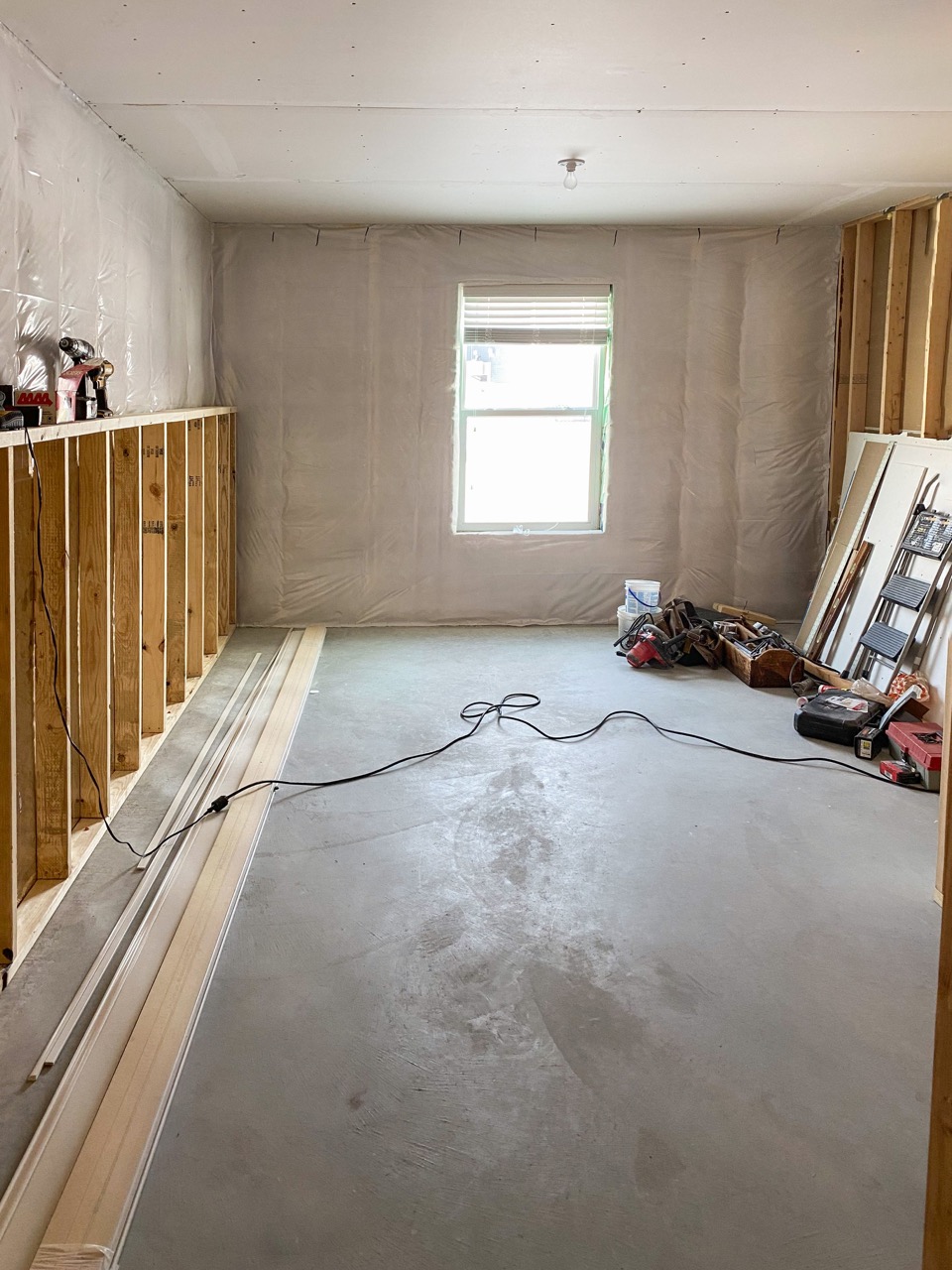 A bedroom mid-renovation features insulation and framing in a home being renovated by House Lift Inc. of the Twin Cities
